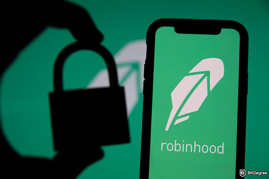 Is Robinhood safe: a silhouette of a hand holding a small padlock and a mobile phone displaying Robinhood's logo.