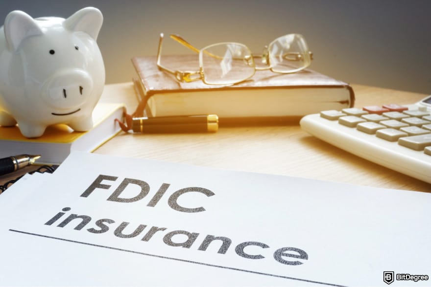 Is Uphold safe: a piggy bank next to a piece of paper with the words FDIC insurance.