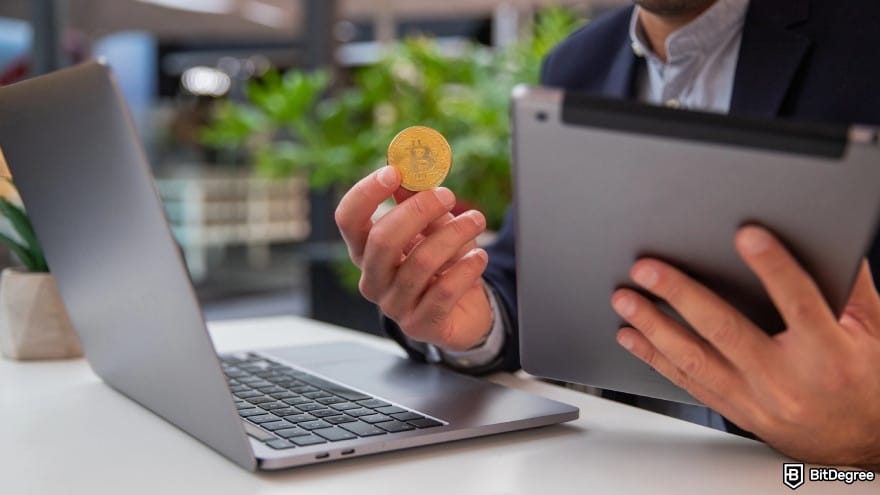 Is Wise available in Pakistan: close-up of a person's hand holding a bitcoin.