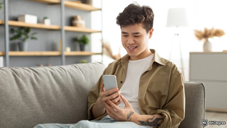Is Wise available in the Philippines: a person smiling using phone at home sitting on couch.