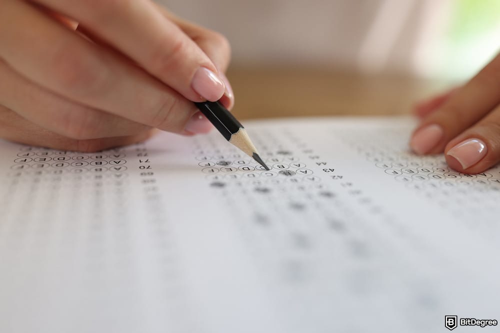 is XRP dead: a woman solving a test with her pencil.