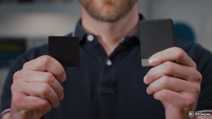 Ledger Recovery Key review: a man holding a Ledger Recovery Key in one hand and a Ledger wallet in the other.