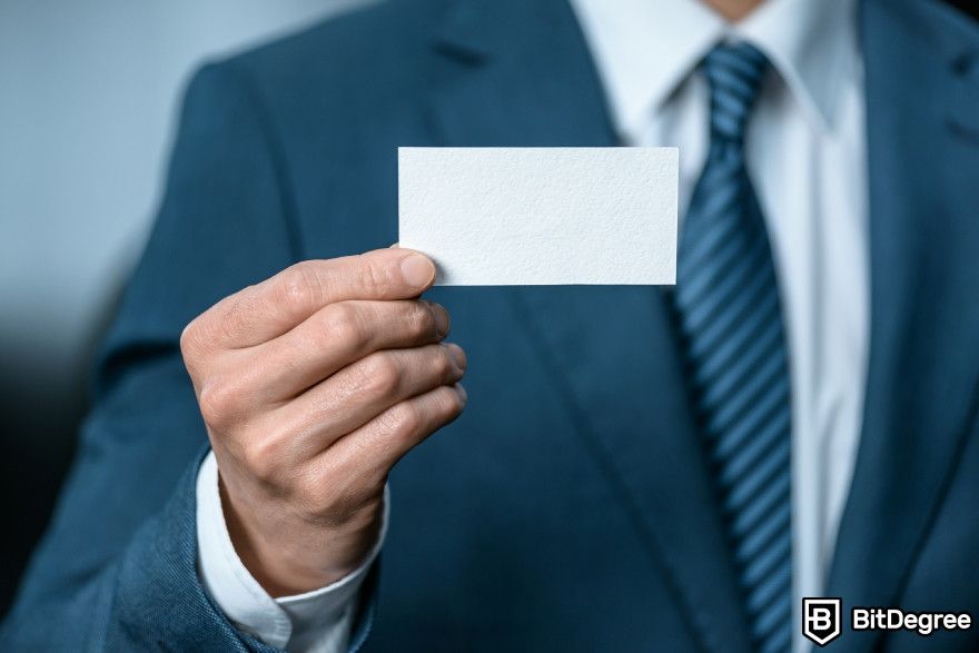 Looka review: A man showing a blank business card.