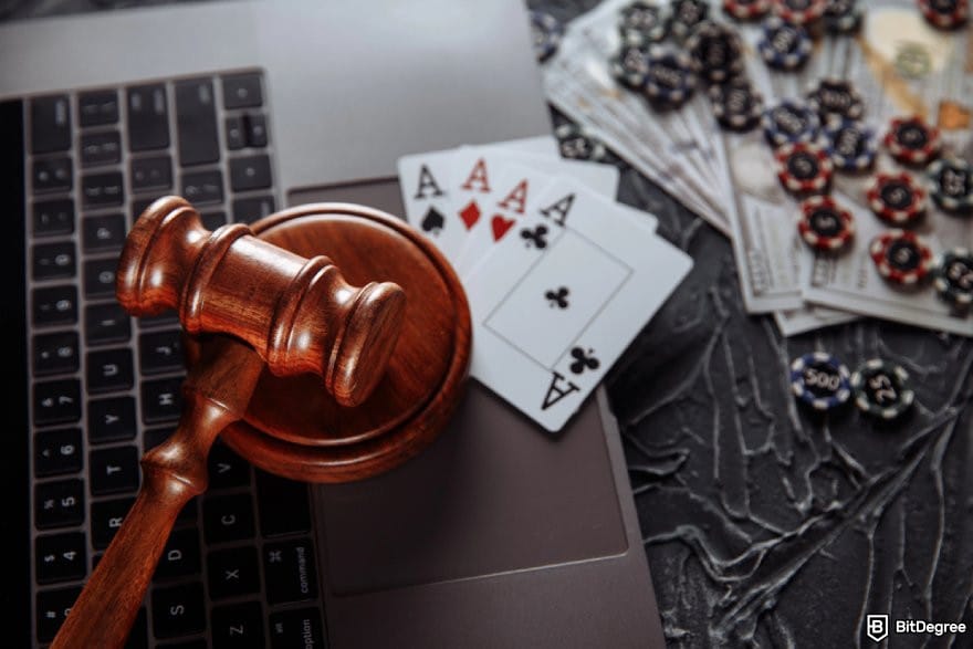 Lucky Rollers casino review: a gavel with cards, dollar bills, and casino chips. Lucky Rollers casino review: a gavel with cards, dollar bills, and casino chips.