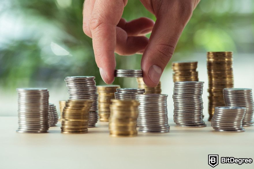 Machine learning vs AI: hand putting coins into piles.