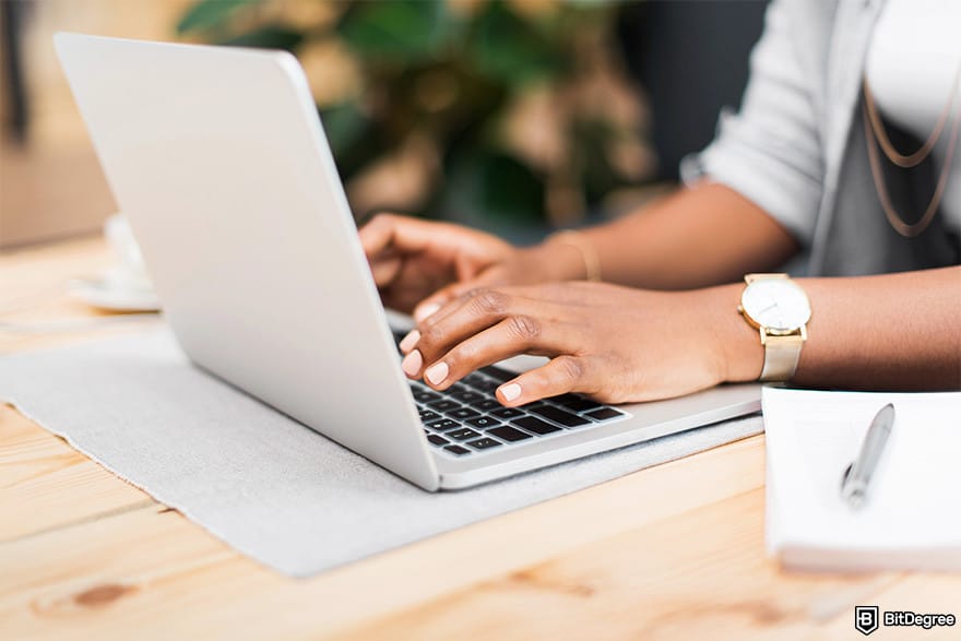 Monero mining: A woman with a laptop.