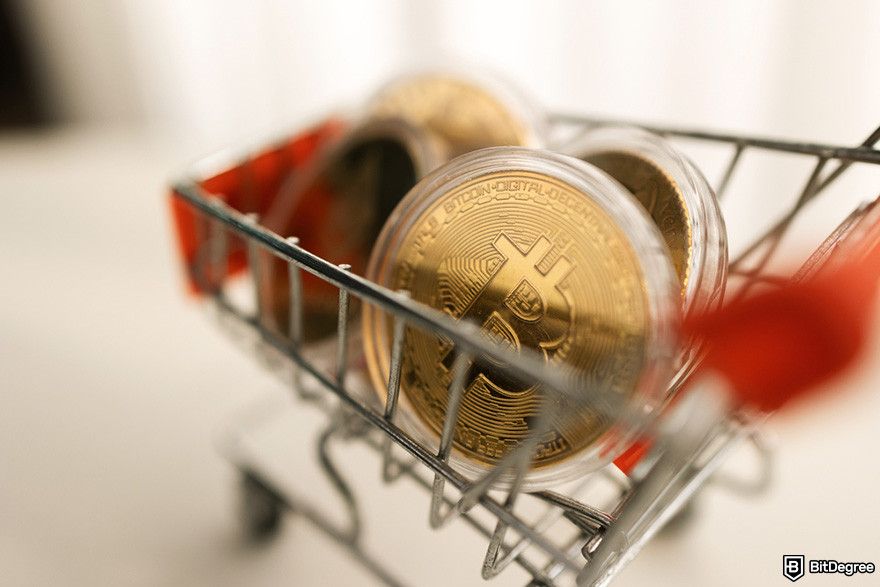 Next crypto to hit $1: Gold BTC coins inside a trolley cart.