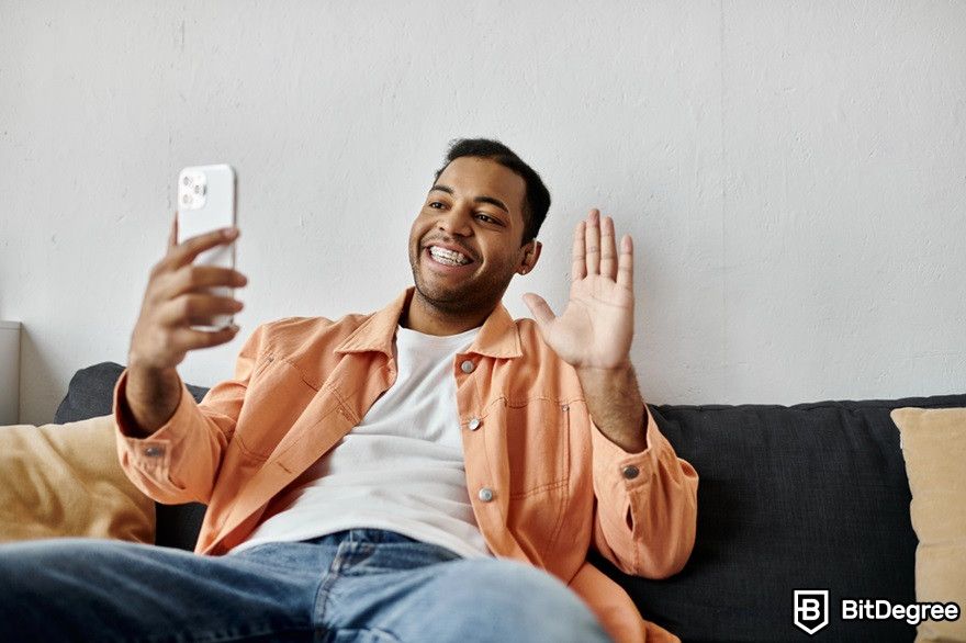 NFT Discord: a man having a video call with his phone.