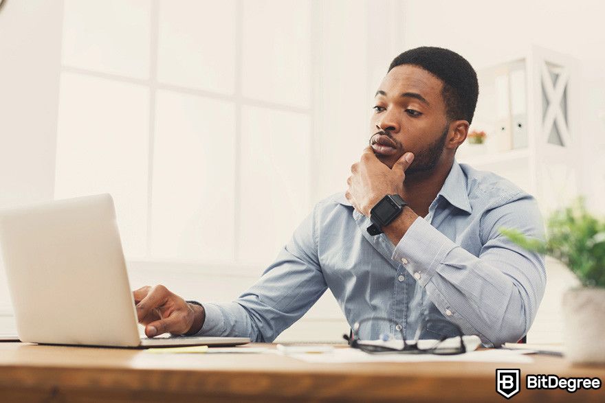 Notcoin Bybit: a person sitting while thinking in front of a laptop.