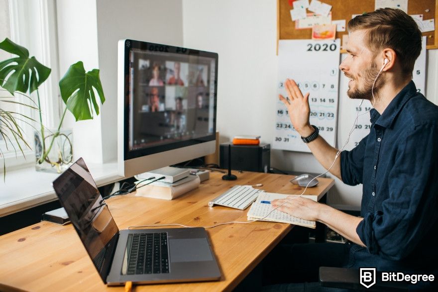 Otter.ai review: A man having an online meeting on his computer.