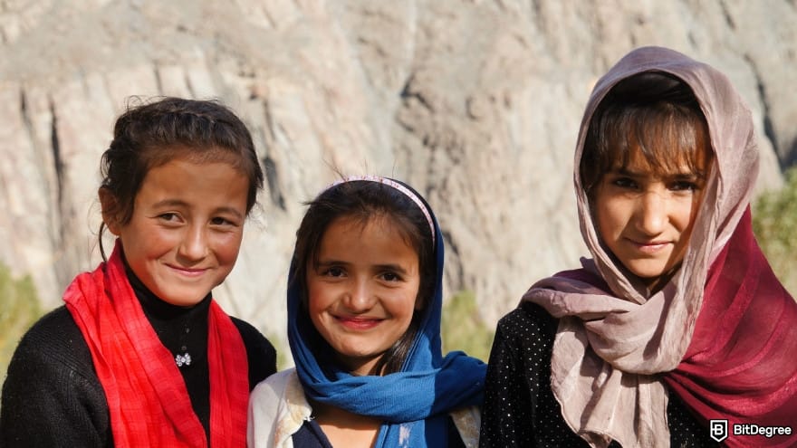 Pakistan currency: three girls smiling at camera.