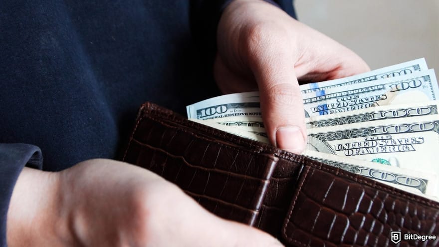 Pakistan currency: a person taking out money from wallet.