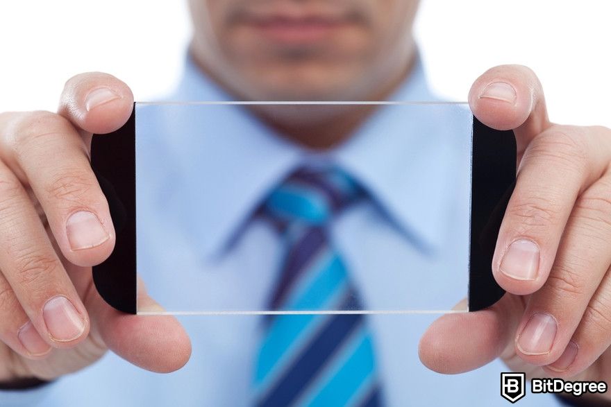 Polkadot staking: businessman holding a transparent object.