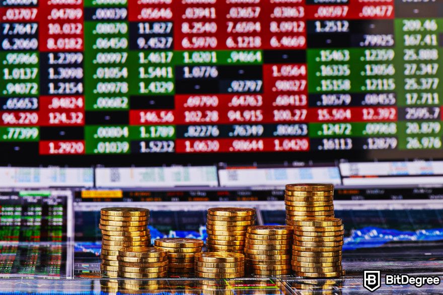 Polygon staking: gold coins arranged on a table set against the backdrop of a market screen.