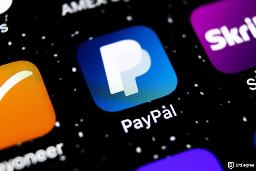Polymarket review: the PayPal app icon on a phone screen.