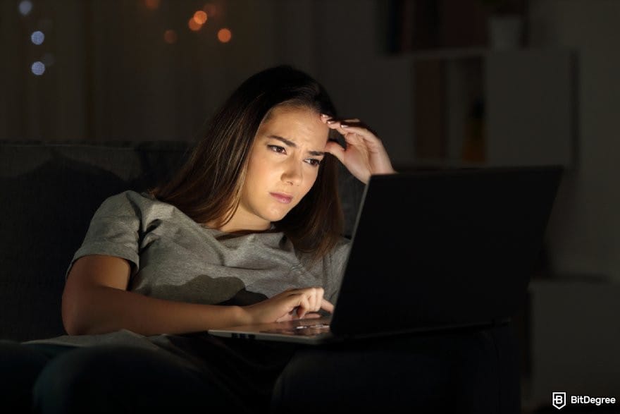 Polymarket review: a person looking at a laptop screen looking frustrated.
