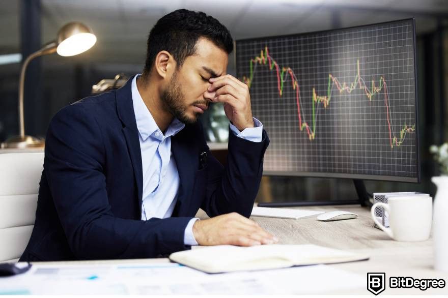 Pump and dump crypto: A man in suit disheartened seeing market trends on screen