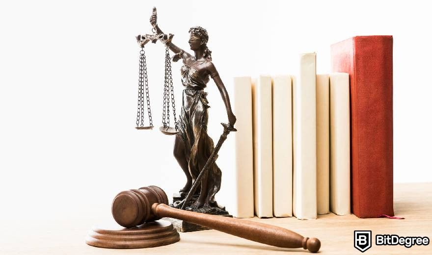 Real World Asset Crypto: a figurine with scales of justice, a gavel, and books.