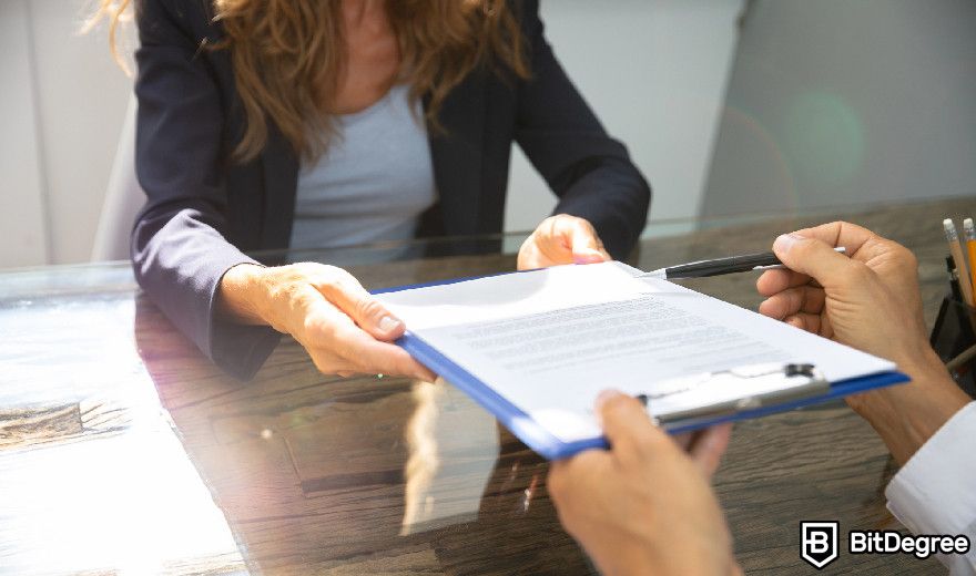 Real World Asset Crypto: a person signing a legal paperwork.