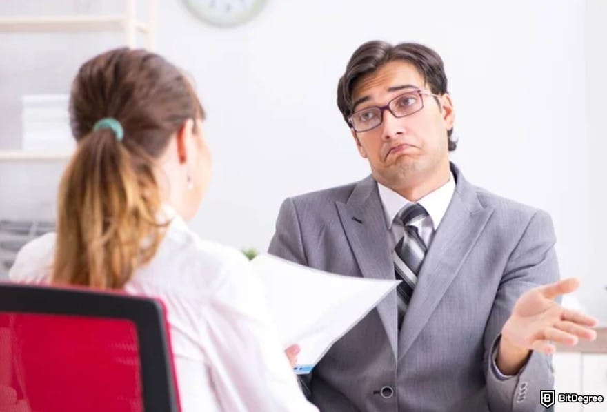 Royal Q review: an uncertain businessman sitting across from client.