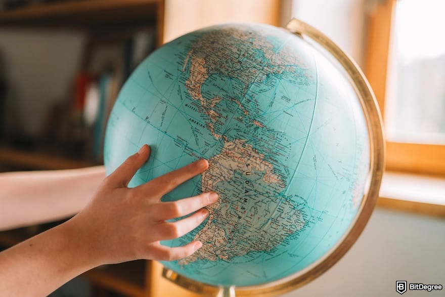 Safest way to send money: hands on a globe.