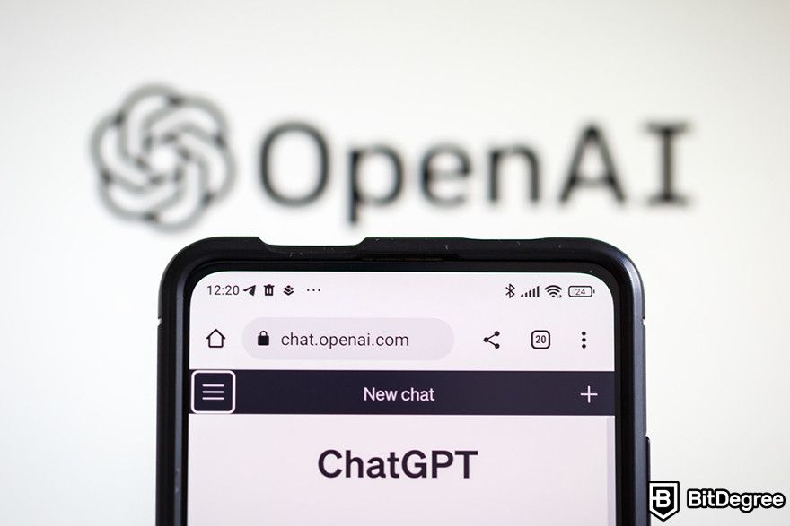 Token de software: um telefone celular exibindo a página da web do ChatGPT na frente do logotipo da OpenAI.