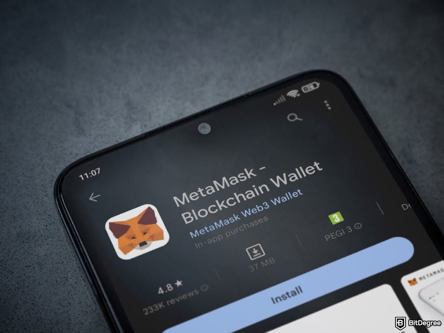 Stake casino review: a phone displaying MetaMask's app page on Google Play.