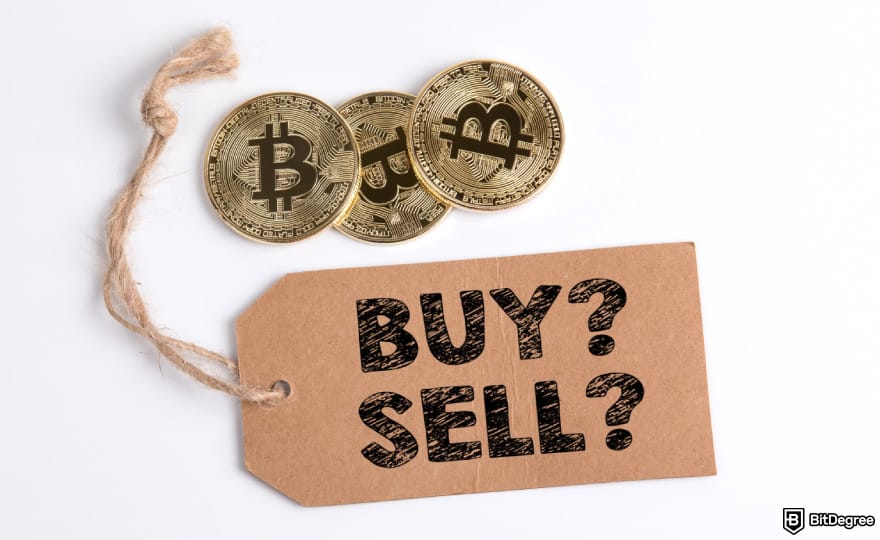 Stop loss in crypto: a paper tag with the words BUY? SELL? next to three Bitcoins.
