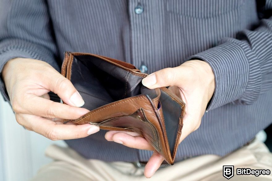 Token gating: a man checking his empty wallet.