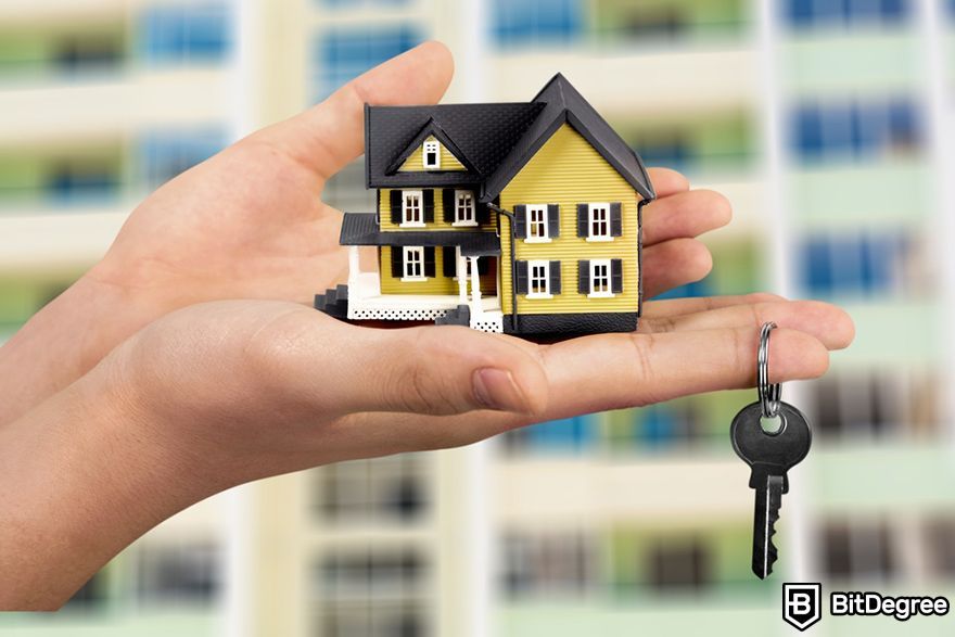 Tokenization meaning: a person holding a house miniature and a key.