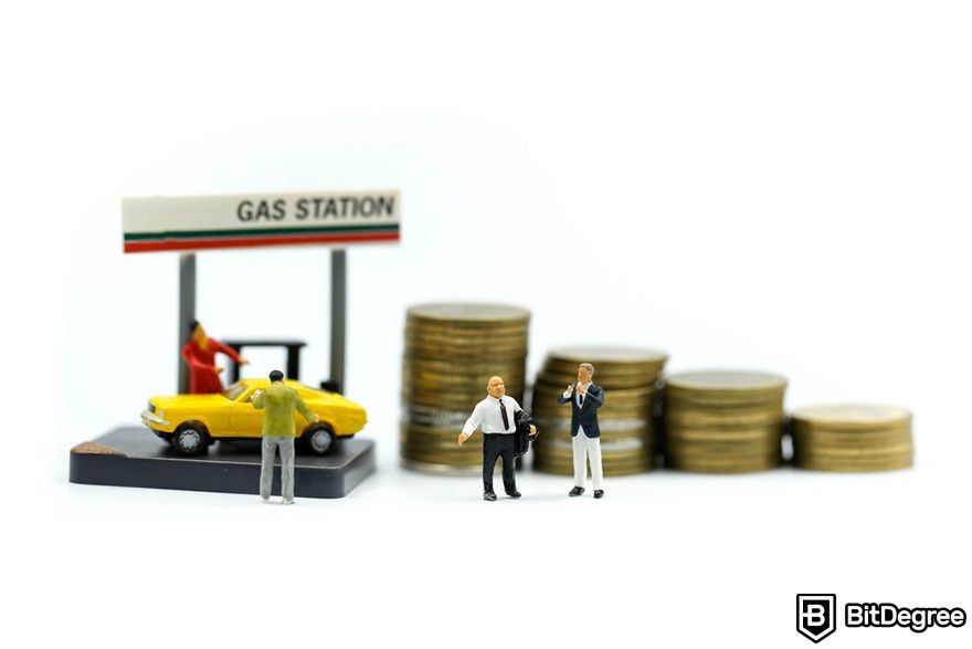 Top Ethereum projects: miniature figures at a miniature gas station with four stacks of coins.