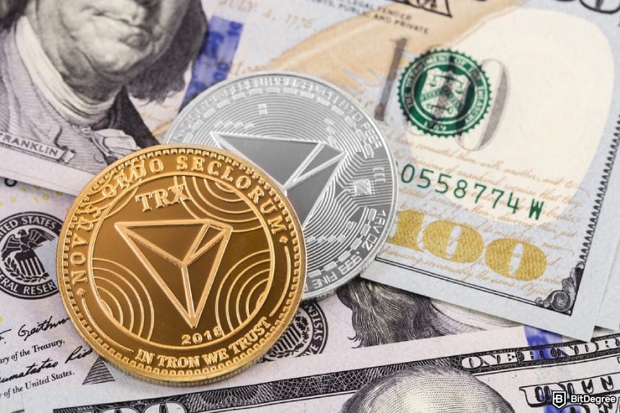 Tron wallet: TRX coins on a pile of $100 bills.
