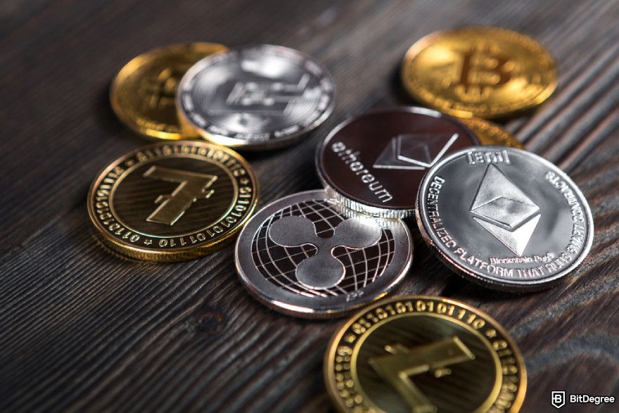 Types of crypto exchanges: silver and golden coins with Bitcoin, Ripple and Ethereum symbol.