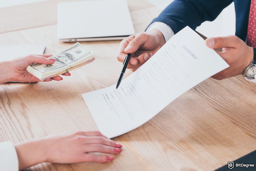 Types of crypto exchanges: a businessman pointing at signature place in loan agreement.