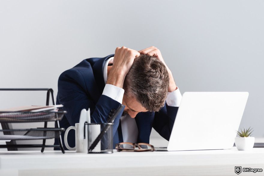 Types of crypto exchanges: a person stressed out in front of a laptop.