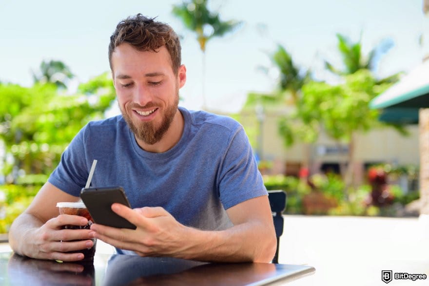 Vavada review: a person looking at a phone while smiling. Vavada review: a person looking at a phone while smiling.