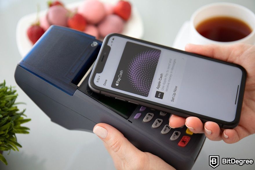 Virtual currency: A phone displaying Apple Pay on a terminal.