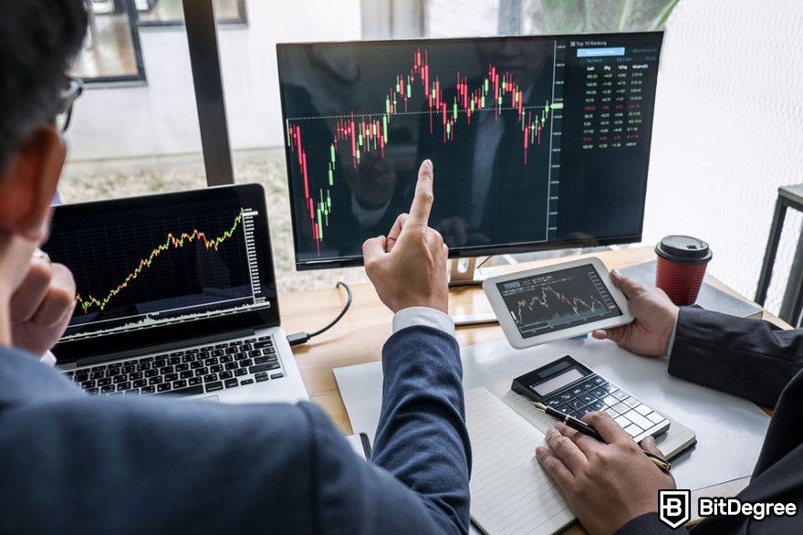 Virtual currency: People working on computers displaying trading graphs.