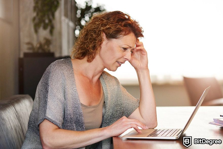 Virtual currency: Woman looking at a laptop, confused