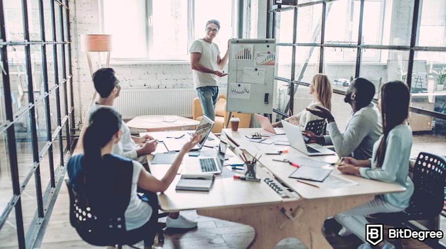 Web3 jobs: a group of people having a meeting in a modern office setting.