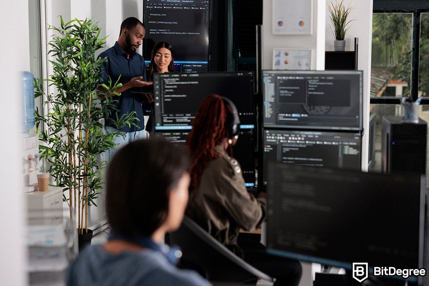 Web3 jobs: software engineers working on desktop computers with multiple monitors.