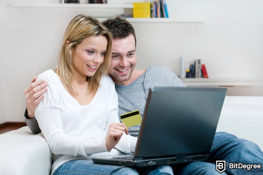 What is AMP crypto: A happy young couple doing internet shopping.