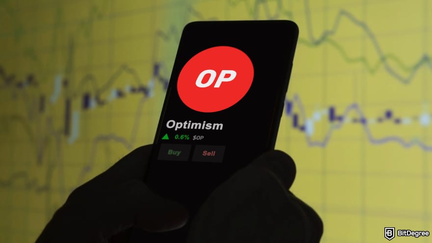 What is Base crypto: the Optimism coin on a phone screen.