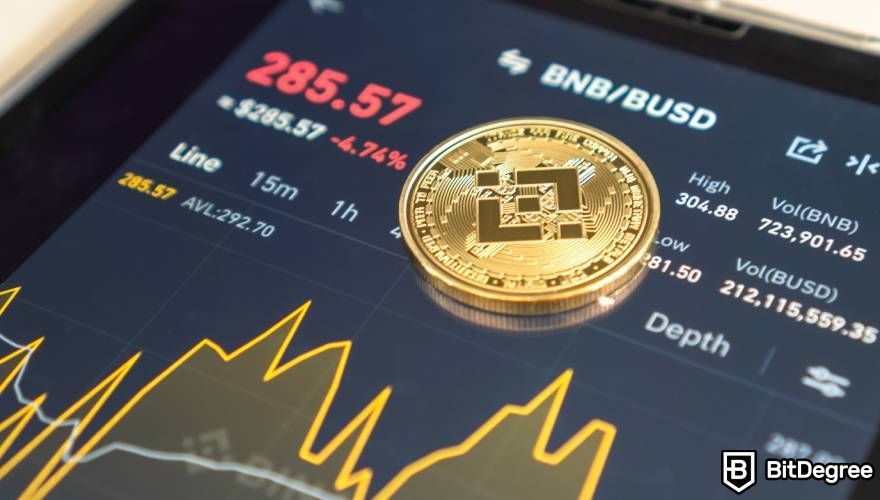 BNB là gì: Đồng xu Binance được đặt trên điện thoại hiển thị thông tin BNB.