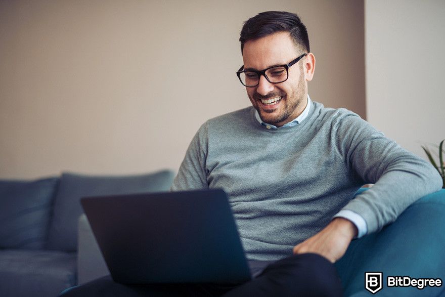 What is Bybit: a person using a laptop while smiling.