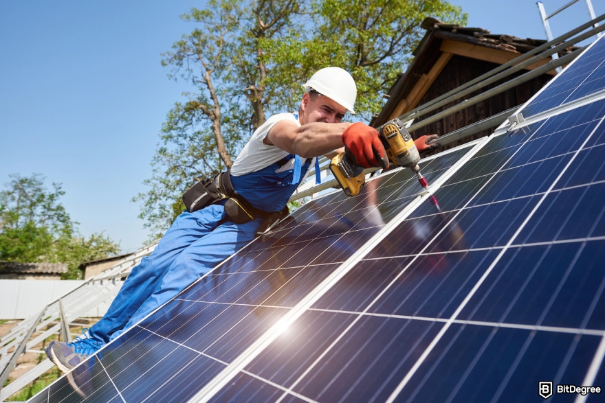 What is DePIN: a man drilling a solar panel.