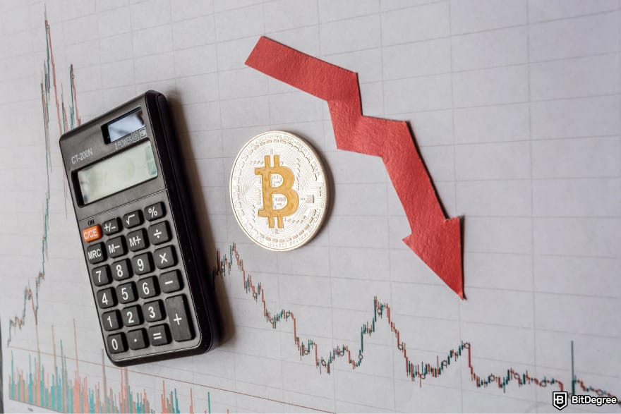 What is double-spending in blockchain: a Bitcoin next to a calculator and a red downward arrow on a market chart.