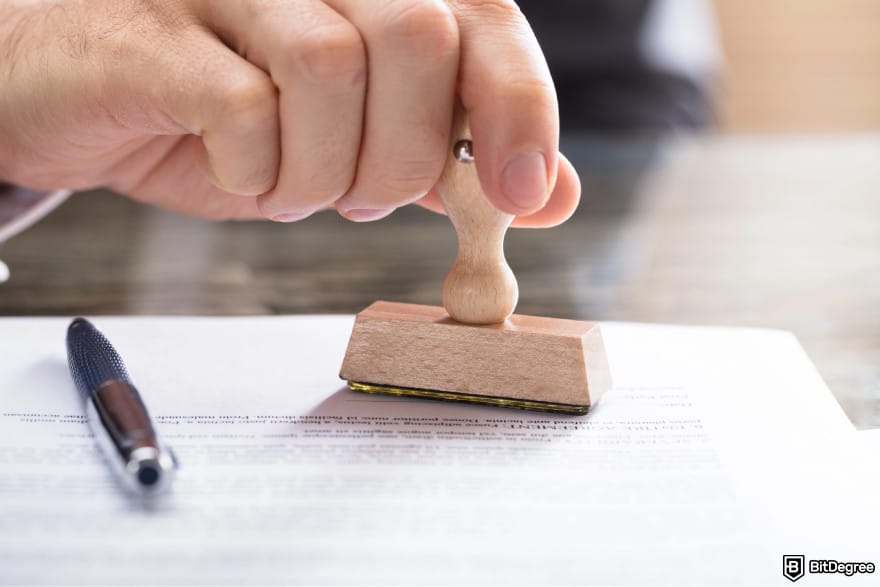 What is double-spending in blockchain: a person stamping over a document.