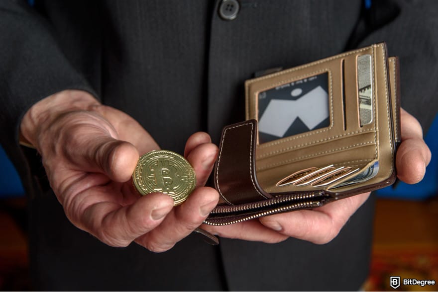What is double-spending in blockchain: a person holding a Bitcoin in one hand and a wallet in another.