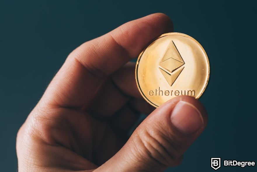 What is EIP-1559: a person holding an ETH coin.